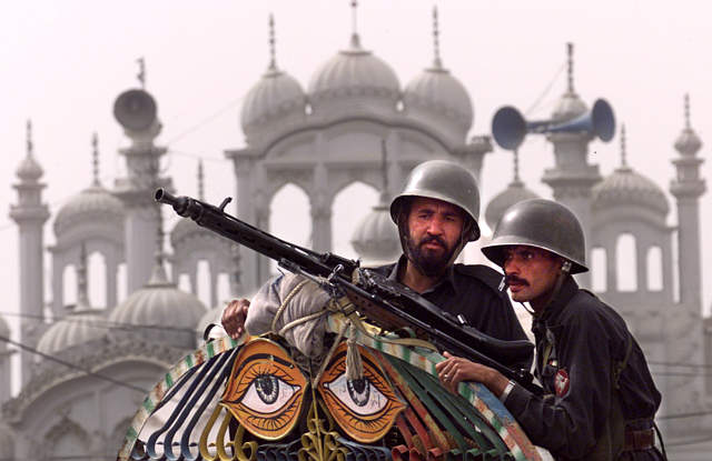 Pakistani policemen stand Pakistani policemen stand. Pakistani policemen stand
